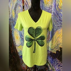 Small lime green V-neck, short sleeved tee with clover